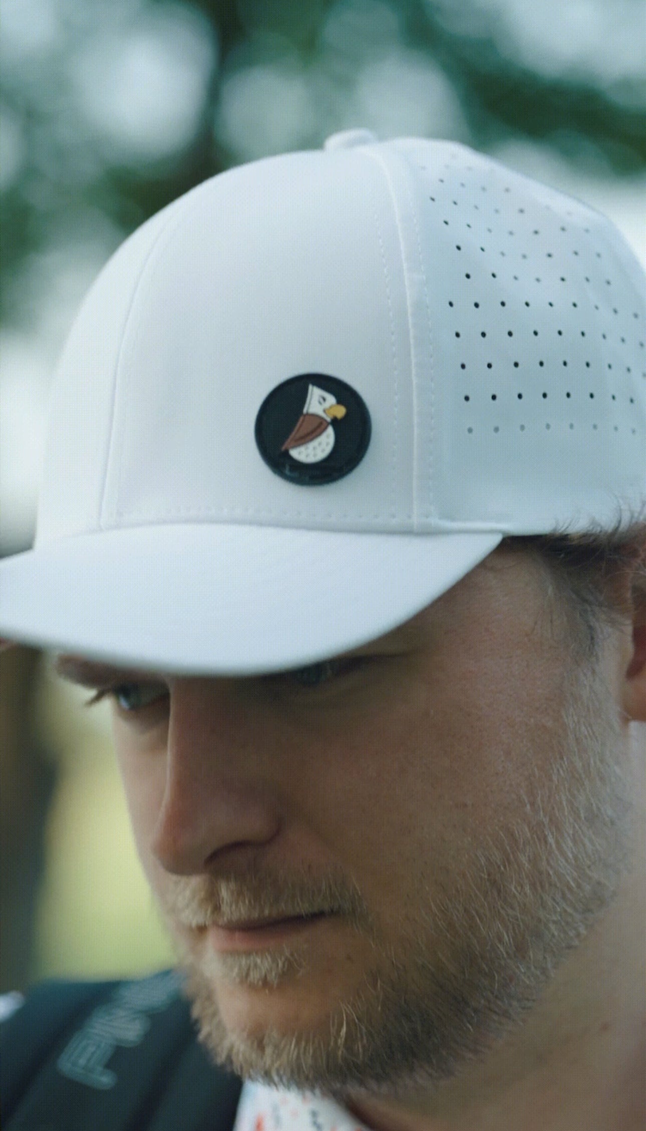golfer wearing moisture-wicking hat to keep sweat out of eyes